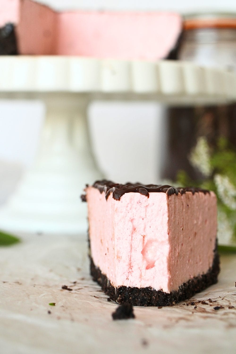front view of a slice of keto no-bake strawberry cheesecake with a bite