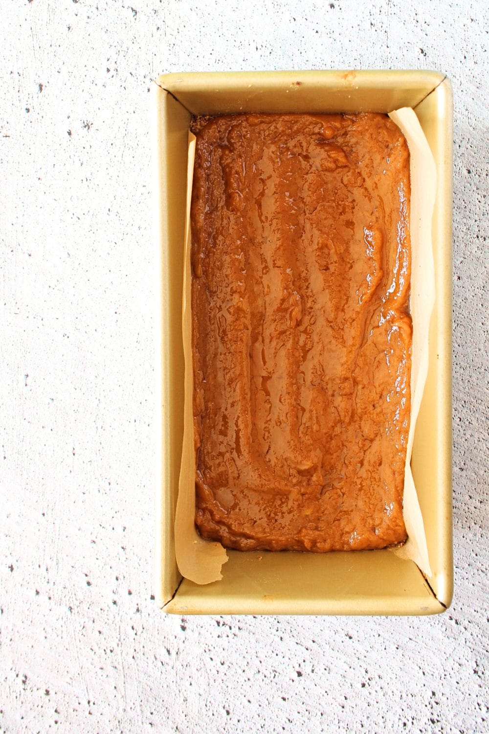 top view of loaf pan with layer of sugar-free high protein caramel for millionaire caramel protein bars
