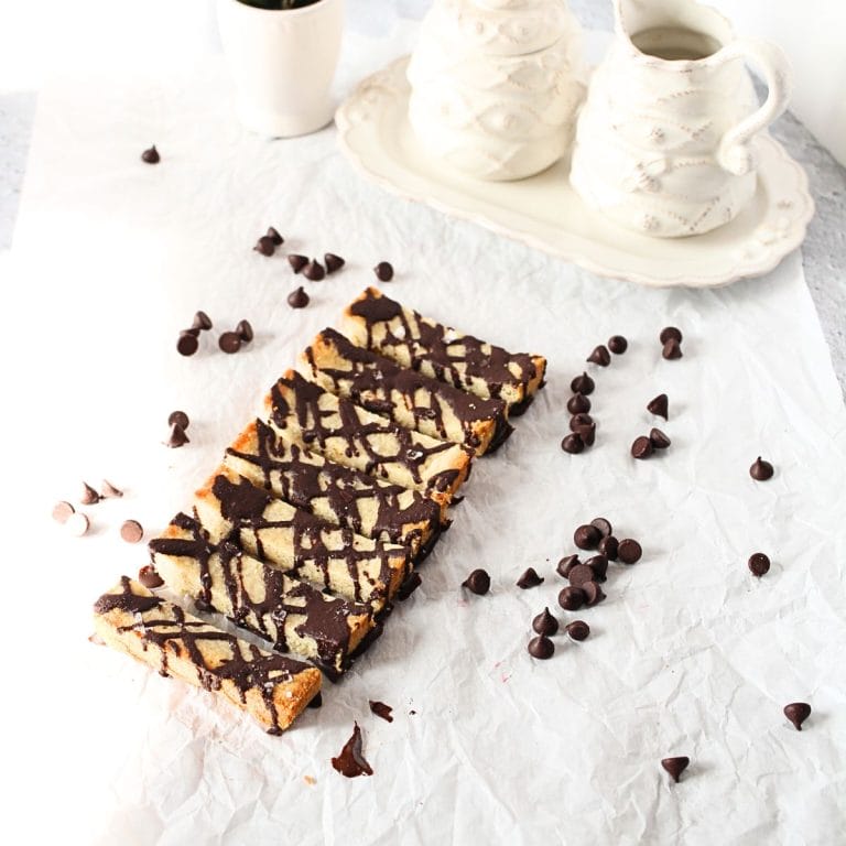 front view of keto shortbread bars wtih chocolate chips scattered around the bars