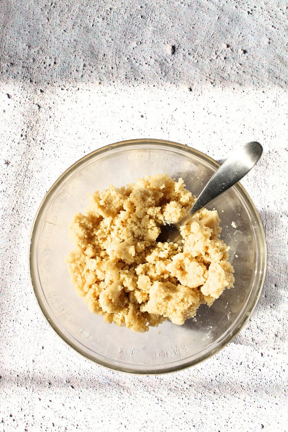 top view of a bowl with easy keto cookie bar ingredients of almond flour, sweetener, whey and butter