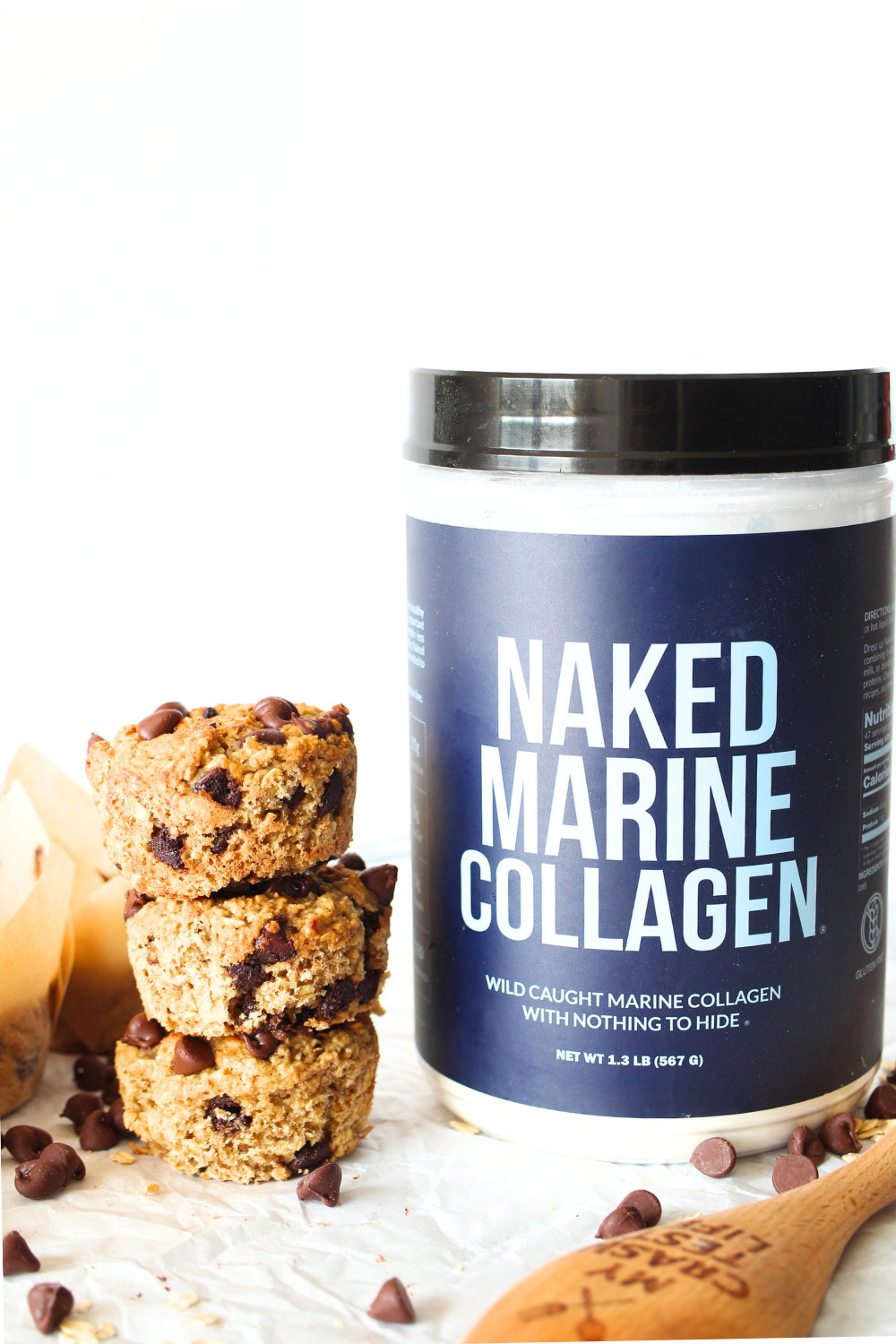 3 healthy chocolate chip muffins staked on top of each other next to a jar of Naked Marine Collagen
