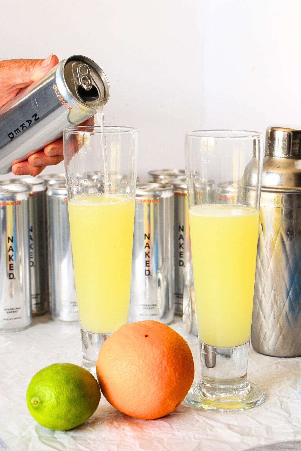 sugar-free pineapple cocktail with pouring of added Orange Energy by Naked nutrition