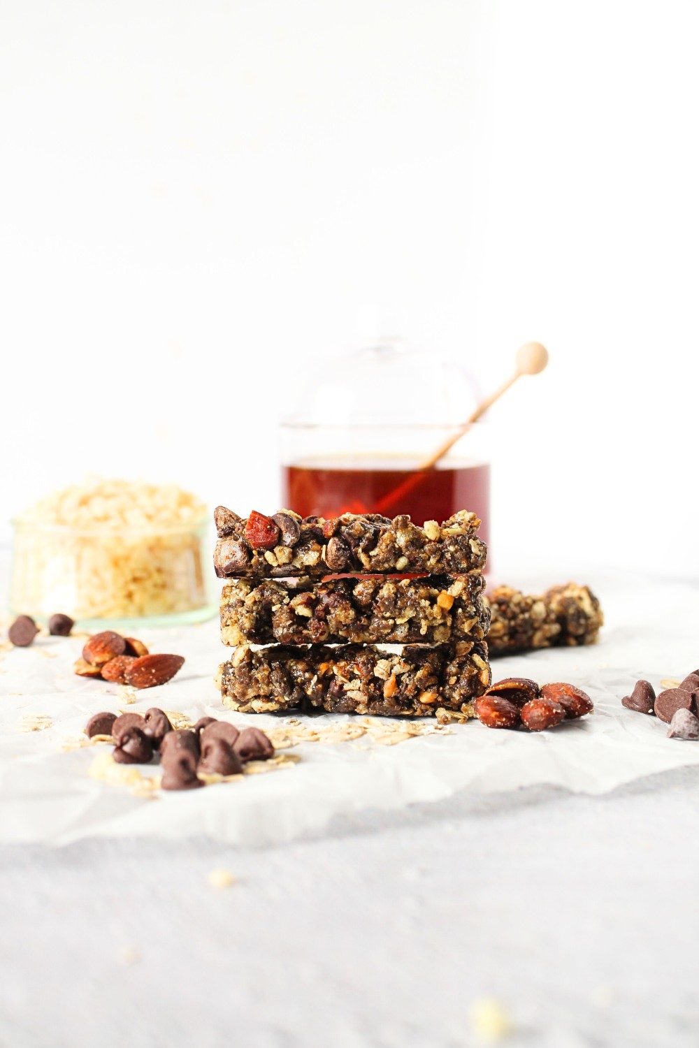 front view of homemade fasting mimicking diet plan bars that have teh same macros as prolon choco crisp bars with rice cereal and honey in the background