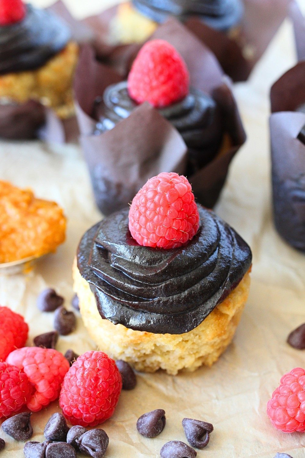 top view of keto 2-ingredient frosting on a cupcake with a raspberry