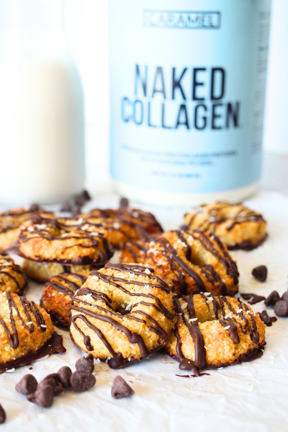 keto collagen cookies stacked on top of each other with a glass of almond milk in the background