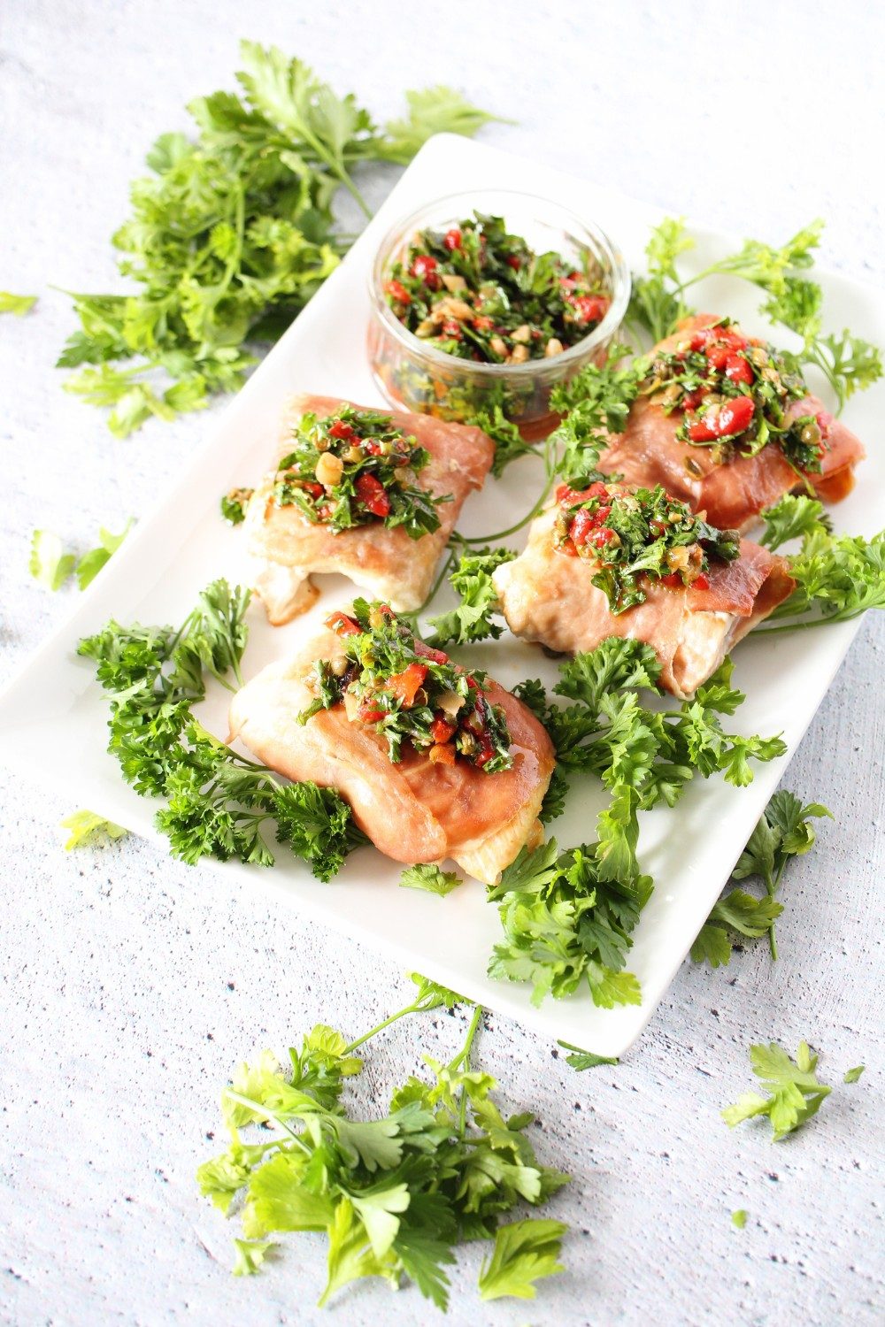 salmon wrapped in prosciutto with keto red pepper herb sauce