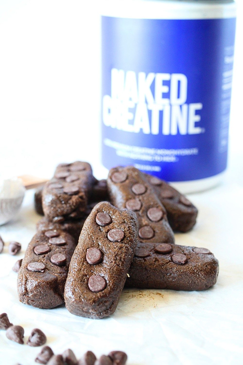 no-bake creatine bars scattered in front of Naked nutrition creatine