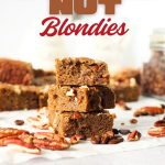 keto coffee nut blondies that are high in fiber stacked on top of each other with nuts scattered about