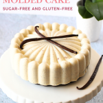 front view of keto french vanilla molded cream cake with vanilla beans on top