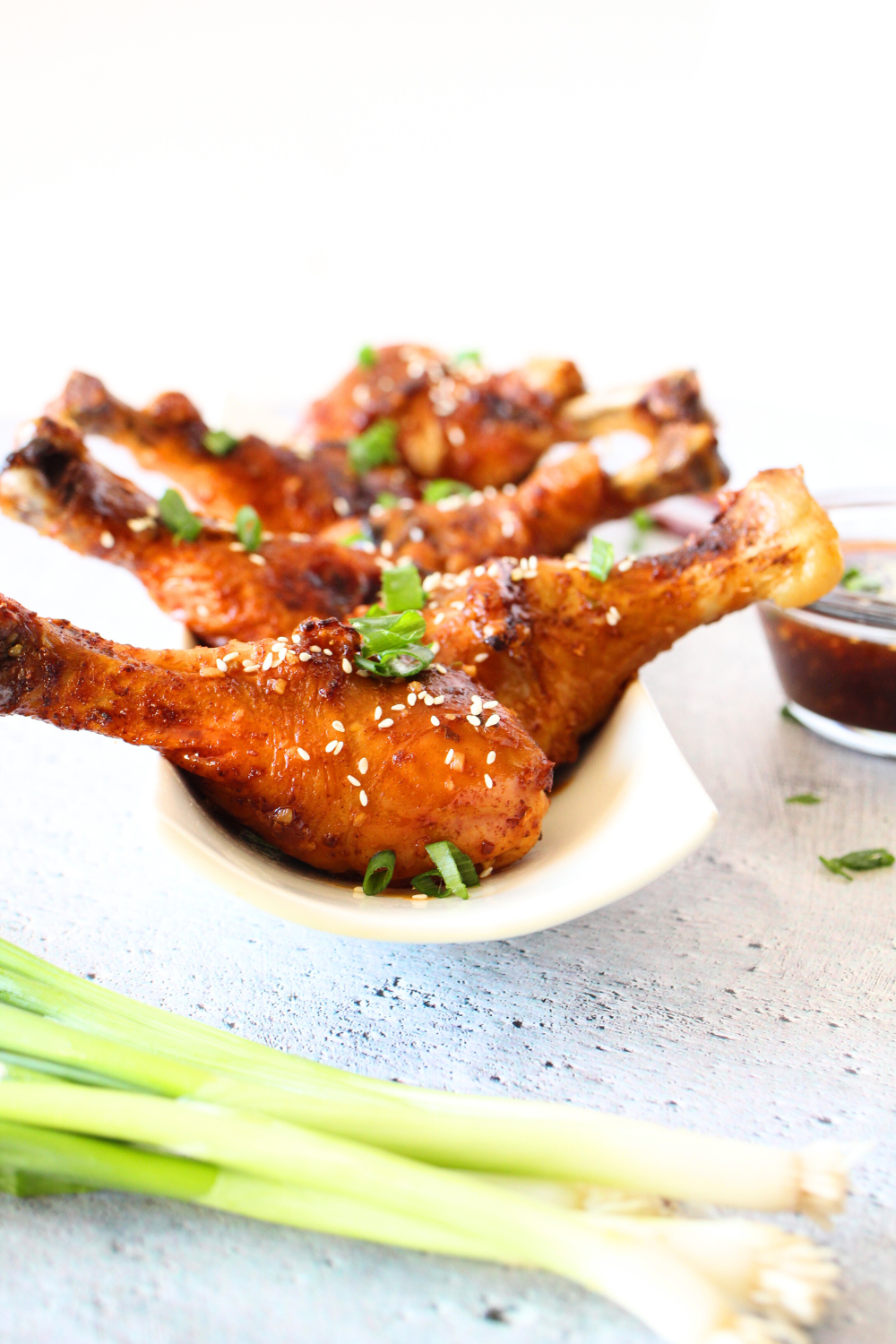 keto baked sweet and sour drumsticks with sesame seeds and green onions